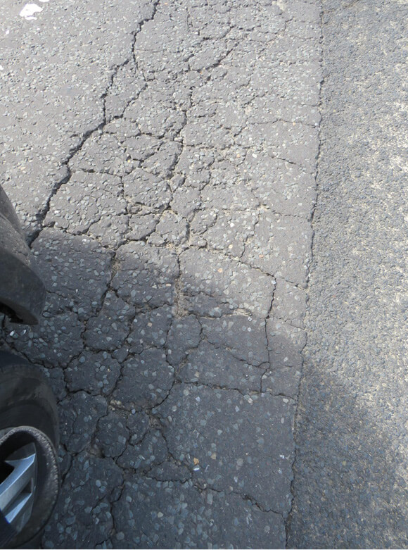 Severe alligator cracking on the road