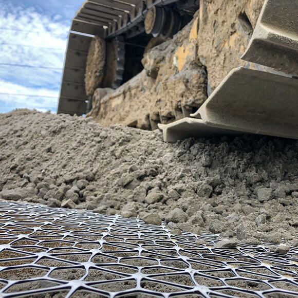 A construction vehicle on top of substrate placed over Tensar's geogrids